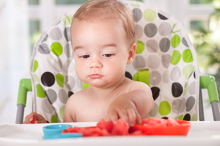 Baby eating watermelon with hands
