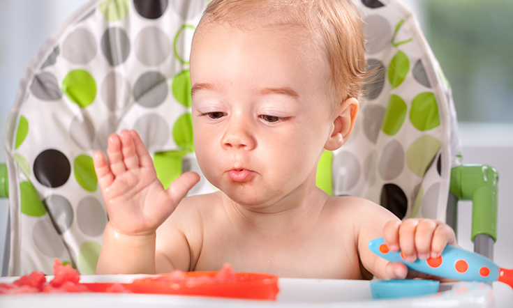 Happy baby eating watermalon